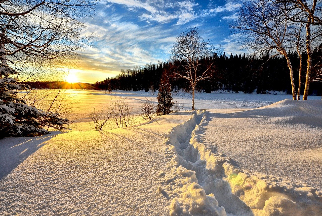 A snowy landscape at sunset.